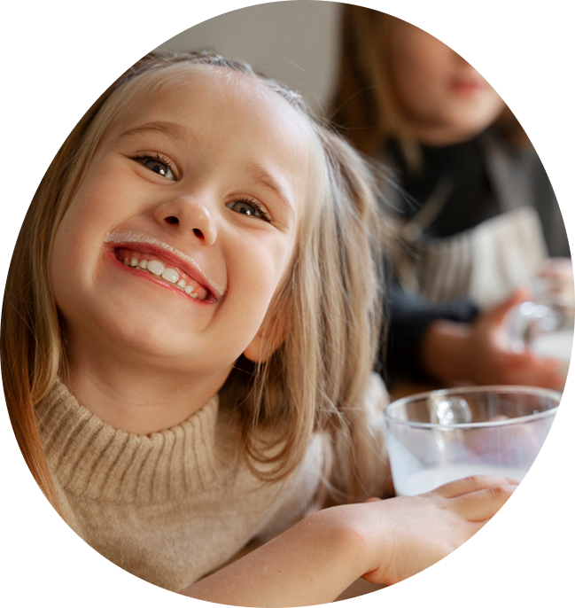 Smiling child holding a glass of water, illustrating the benefits of Water Pure Texas’s renter-friendly filtration system