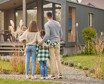 Family standing outside modern home, representing personalized whole house water filtration solutions from Water Pure Texas