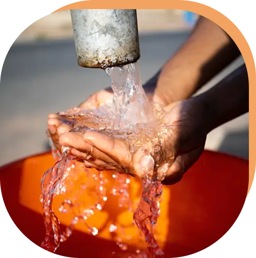 Close-up of hands testing water, illustrating transparency and education