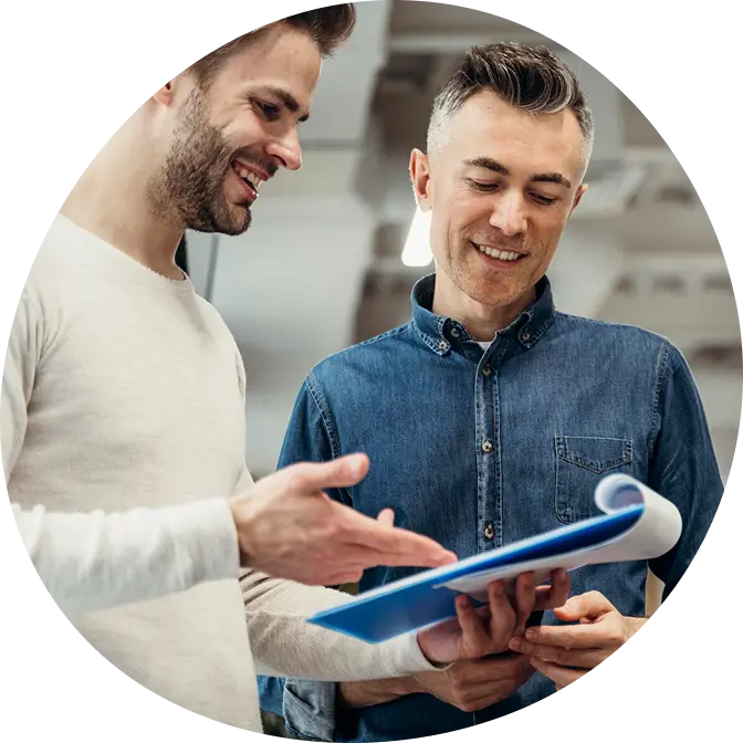 Happy customers reviewing paperwork, reflecting great service and installation experience with Water Pure Texas